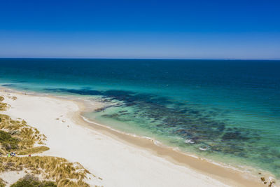 Scenic view of sea against clear blue sky