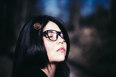 Close-up portrait of young woman in sunglasses