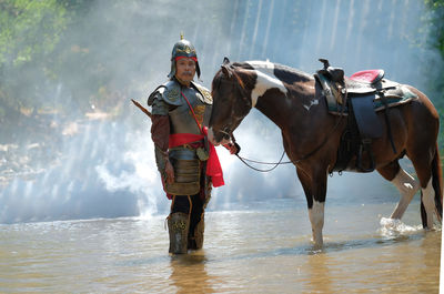 Portrait of emperor with horse standing in river