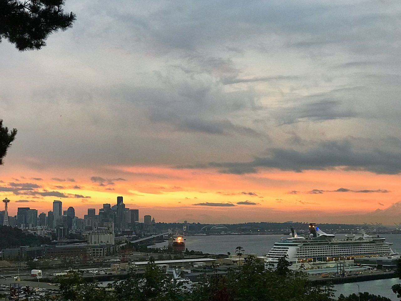 VIEW OF CITYSCAPE AGAINST CLOUDY SKY