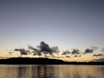 Calm lake with trees in background