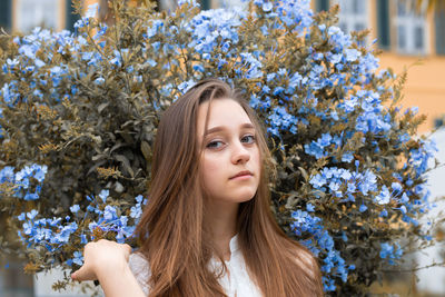 Portrait of young woman looking at camera