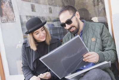 Young couple looking at records