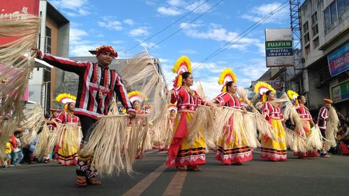 Panoramic view of people on street against sky in city