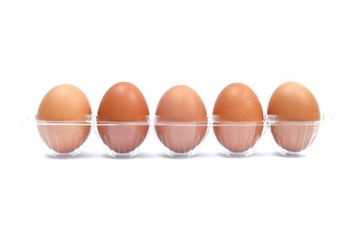 Close-up of eggs against white background