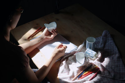 Woman painting on paper