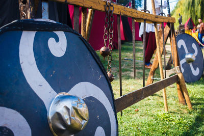 Close-up of clothes hanging on clothesline on field
