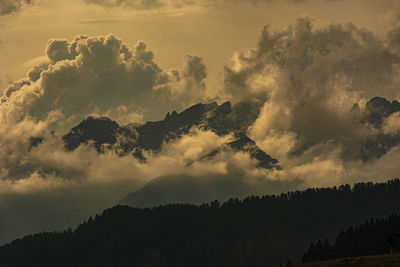 Low angle view of silhouette mountain against sky at sunset