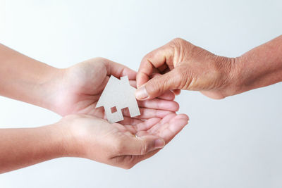 Close-up of hands over white background