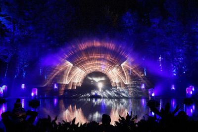 People enjoying illuminated fountain at night