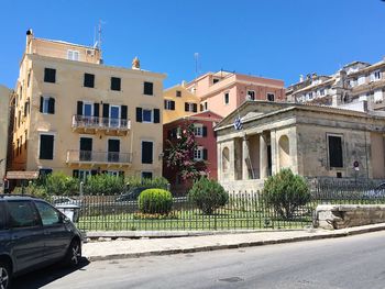 Cars on road against buildings