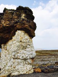 Low angle view of rock formation against sky