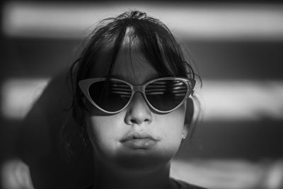 Close-up portrait of young woman wearing sunglasses