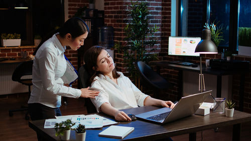 Young woman using laptop at table