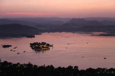 Scenic view of lake against sky during sunset