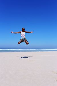 Woman jumping on beach