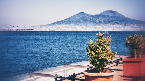 Scenic view of sea against clear sky, with a view on the vesuvius volcano, naples, italy