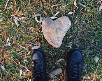 Low section of man standing on heart shape