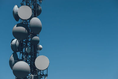 Communications tower against blue sky