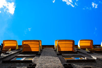 Low angle view of buildings against blue sky