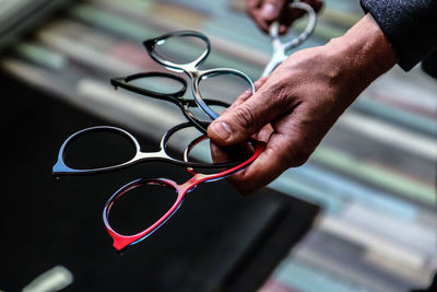 Close-up of man holding eyeglasses