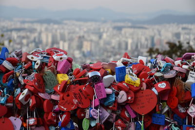 Close-up of padlocks against cityscape and sky