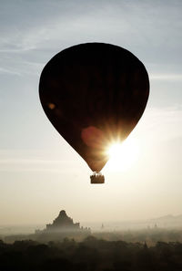 Silhouette of airplane flying in sky