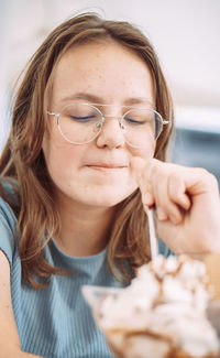 Close-up portrait of young woman eating food