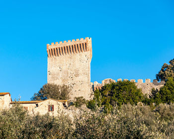 Low angle view of historic building against blue sky