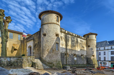 Low angle view of old building against blue sky