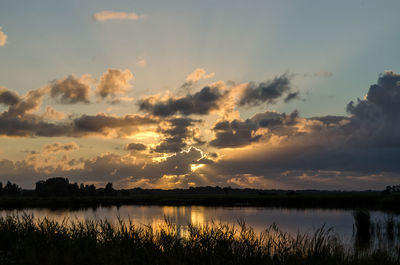 Tranquil view of lake at sunset