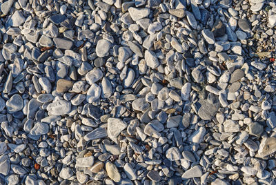 Seamless pattern of polished stones in a rocky beach