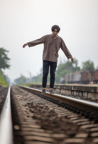 Man walk away on railroad with warm light. selective focus. traveler man on railroad. person