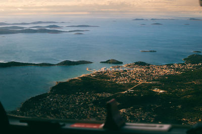 High angle view of rocks by sea against sky