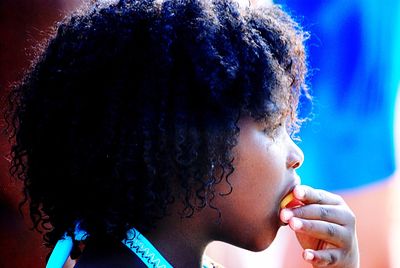 Side view of girl eating food