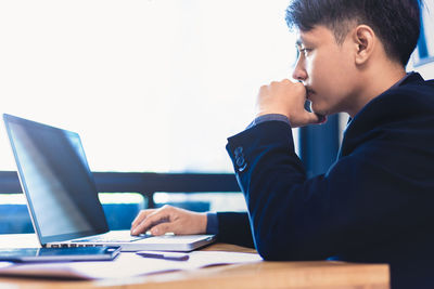 Man using laptop on table