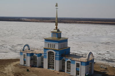 Built structure on beach against sky