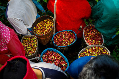 High angle view of people for sale at market stall