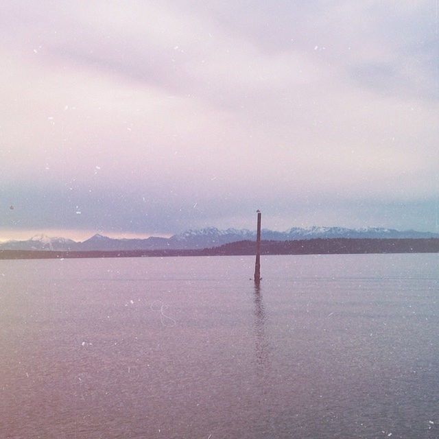 water, waterfront, tranquility, sky, tranquil scene, built structure, scenics, sea, nature, architecture, beauty in nature, weather, connection, river, cloud - sky, outdoors, no people, idyllic, reflection, fog