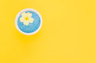 High angle view of drink against yellow background