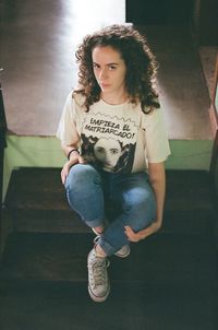 Portrait of a young woman sitting at home