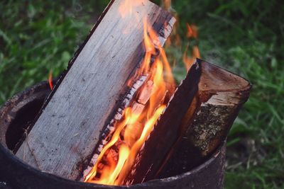 Close-up of burning wood in container 