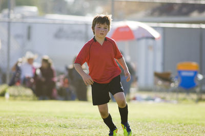 Young boy concentrating on a soccer field