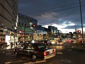 Cars on city street at dusk