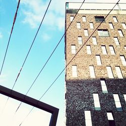 Low angle view of power lines against sky