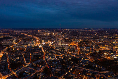 High angle view of city lit up at night