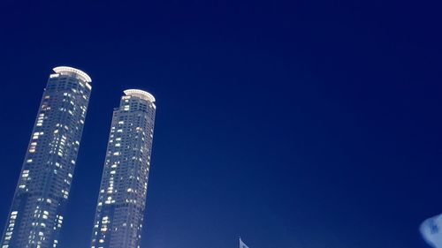 Low angle view of buildings against clear blue sky
