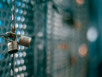 Close-up of padlocks hanging on metal