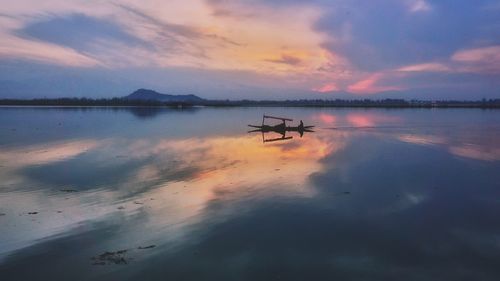 Scenic view of lake against sky during sunset