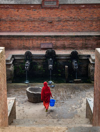 Rear view of boy on temple against building